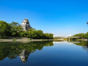 黒漆塗りの外観が特徴の岡山城天守閣。堀の水面に美しく映える姿が印象的。